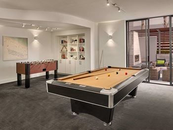 Game room with foosball and pool tables